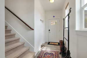 Entrance foyer with hardwood / wood-style floors