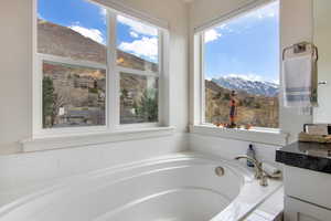 Bathroom with a mountain view and a relaxing tiled tub