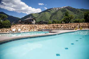 View of swimming pool with a mountain view