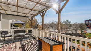 Wooden deck featuring a gazebo