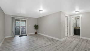 Empty room with light hardwood / wood-style floors