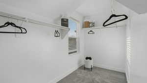 Spacious closet with light colored carpet