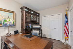 Office area with dark hardwood / wood-style floors