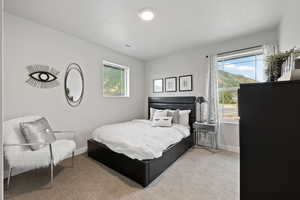 Carpeted bedroom featuring a textured ceiling