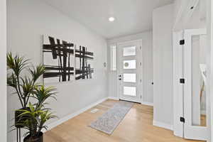 Entryway with hardwood / wood-style floors