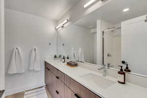 Bathroom featuring vanity, hardwood / wood-style flooring, and walk in shower