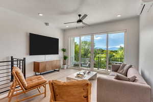 Living room featuring ceiling fan, a healthy amount of sunlight, and light wood-type flooring
