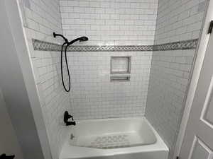 Bathroom featuring tiled shower / bath combo