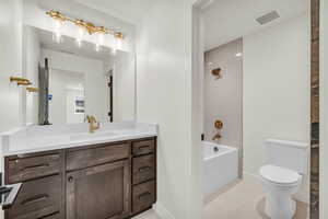 Full bathroom with tile patterned flooring, shower / tub combination, vanity, and toilet