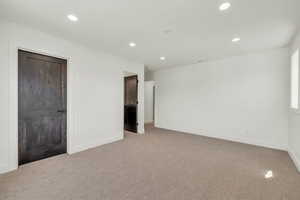 Unfurnished bedroom featuring light colored carpet