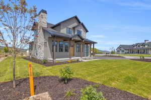 View of front of home featuring central AC and a front lawn