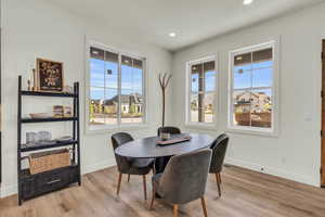 Dining space with light hardwood / wood-style floors