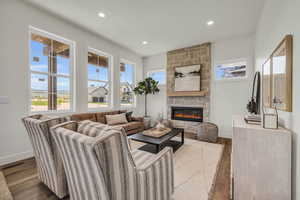 Living room with a fireplace and light wood-type flooring