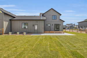 Back of house featuring a patio area and a yard