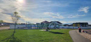 View of community featuring a playground and a yard