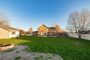 View of yard with a shed, a patio area, and a fire pit