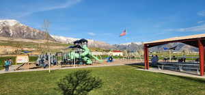 View of play area featuring a mountain view and a yard