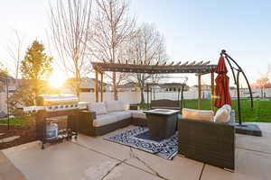 View of patio with a pergola, grilling area, and an outdoor living space with a fire pit