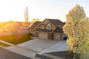 View of front facade featuring a garage and a front yard