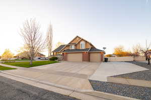 View of front of home featuring a lawn and a garage