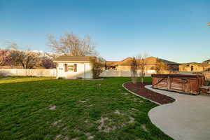 View of yard featuring an outbuilding, a patio, and a hot tub