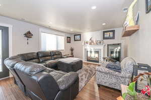 Living room with dark hardwood / wood-style floors and a textured ceiling