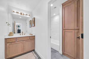 Bathroom featuring vanity and tiled shower / bath