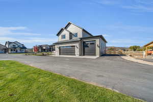 Garage featuring a lawn