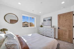 Bedroom with light colored carpet