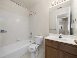 Full bathroom with tile patterned flooring, vanity, toilet, and shower / bath combination