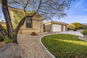 View of front facade featuring a front lawn and a garage