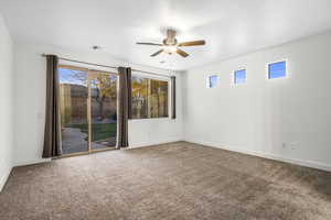 Unfurnished room featuring carpet and ceiling fan