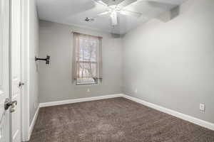 Unfurnished room featuring carpet flooring and ceiling fan