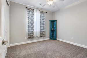 Carpeted spare room featuring ceiling fan and a textured ceiling