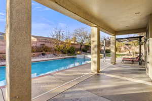 View of swimming pool with a patio area and an in ground hot tub