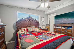 Bedroom with ceiling fan and carpet floors