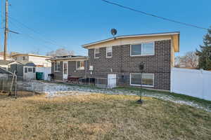 Rear view of property with a lawn