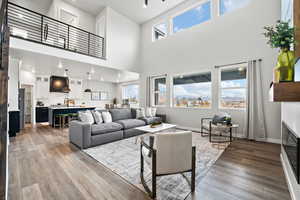 Living room featuring hardwood / wood-style floors, a high ceiling, and sink