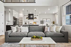 Living room with light wood-type flooring and sink