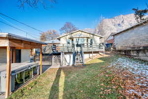 View of yard featuring a deck with mountain view