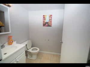 Bathroom featuring tile patterned floors, vanity, and toilet