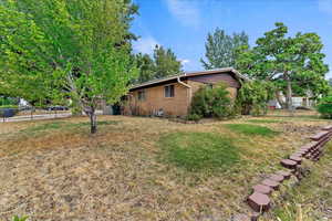 View of property exterior featuring a lawn