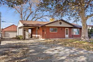 Single story home featuring an outbuilding and a garage