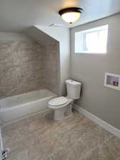 Bathroom with tile patterned flooring and toilet