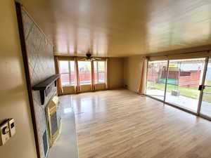 Unfurnished living room featuring light hardwood / wood-style flooring and ceiling fan