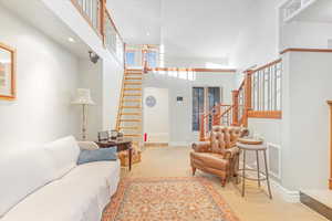 Living room with light carpet and a high ceiling