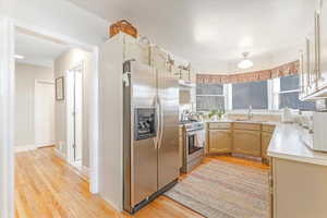 Kitchen featuring light hardwood / wood-style flooring, stainless steel appliances, and sink