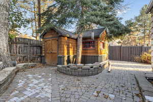 View of patio / terrace featuring a shed