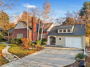 View of front of house with cooling unit and a garage