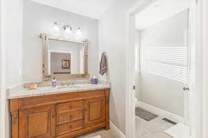 Bathroom with tile patterned flooring, vanity, and toilet